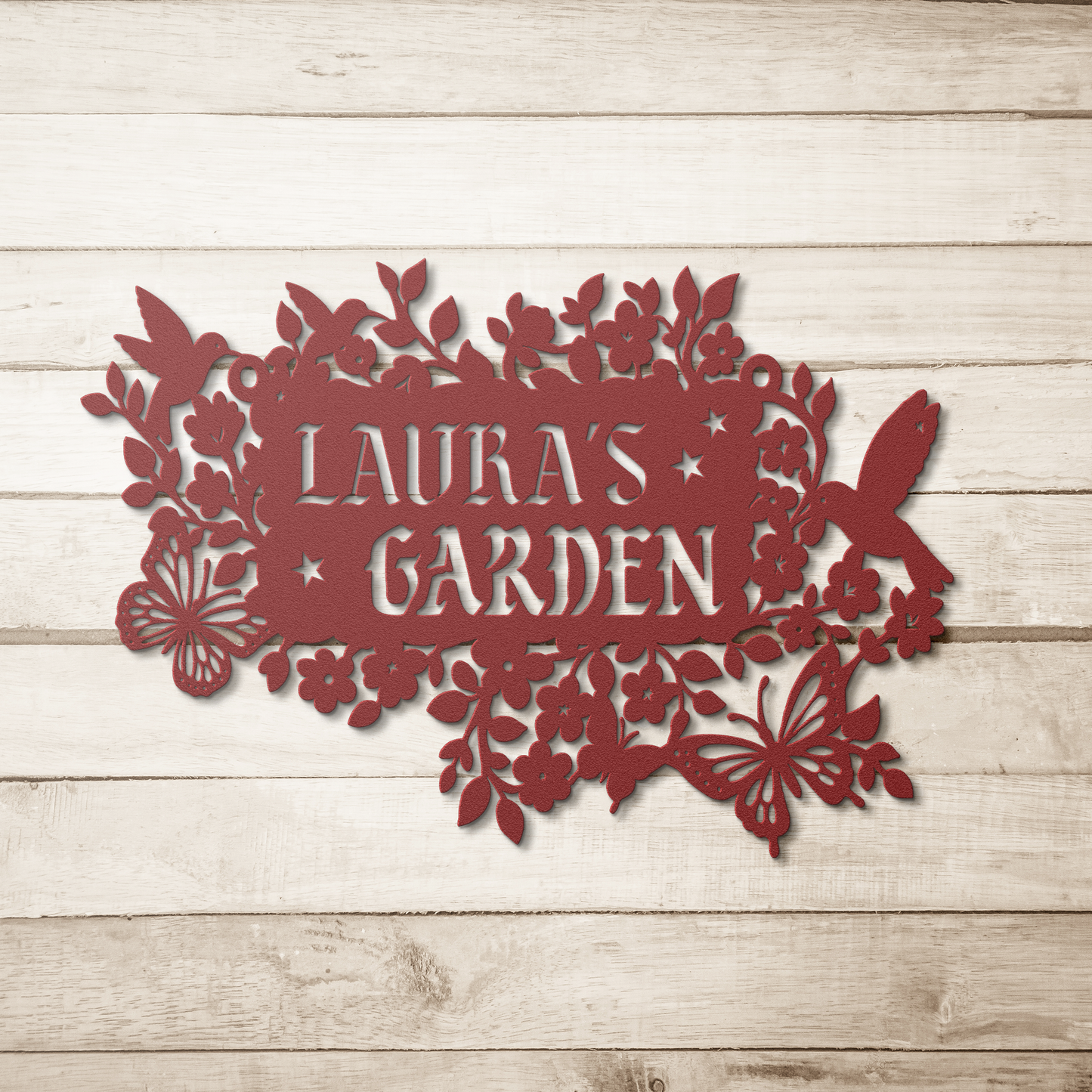 Red custom garden name sign surrounded by blooming flowers